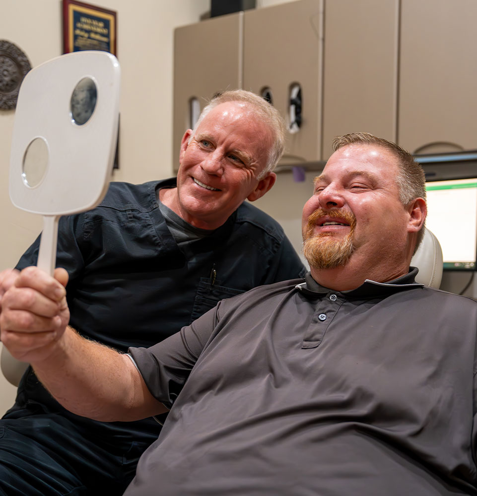 Patient and doctor looking into mirror