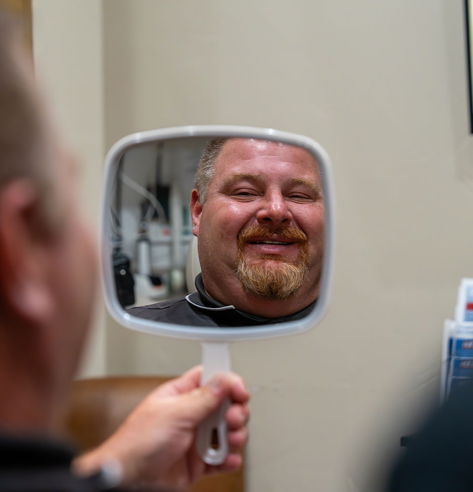 Patient looking into after dental procedure