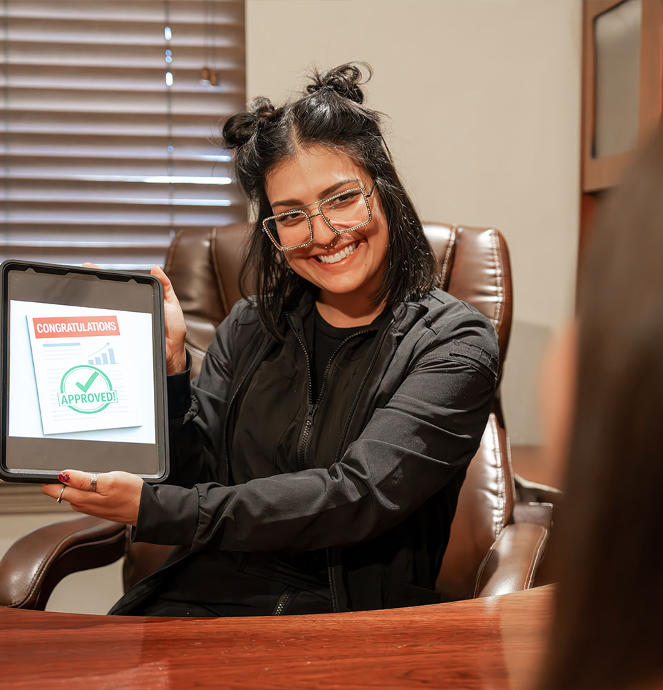 Team member holding up tablet for Patient to see