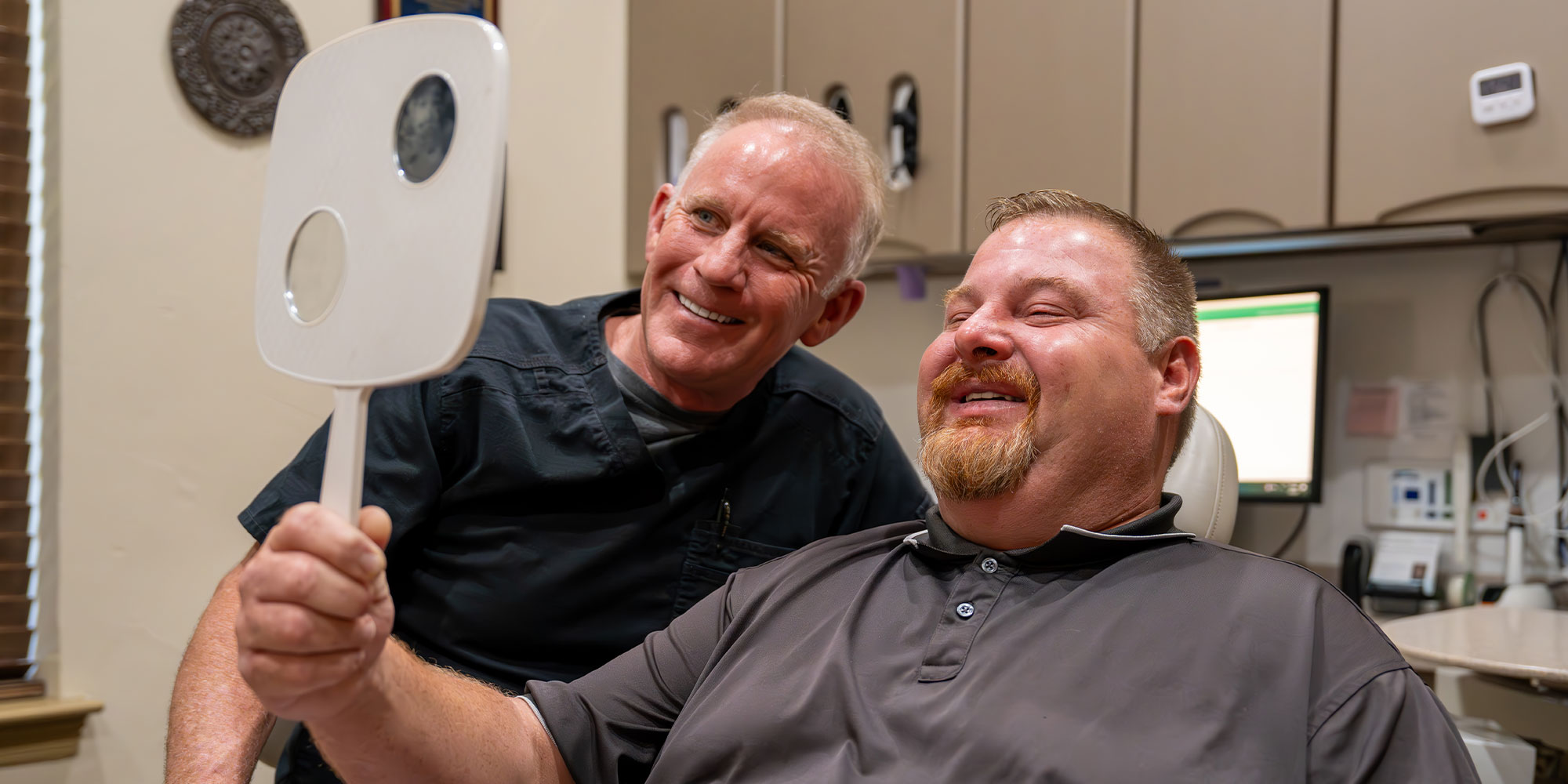 Patient and doctor looking into mirror